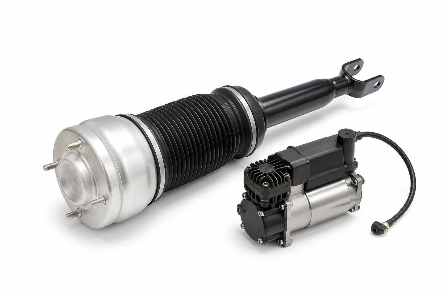 An air suspension strut with black rubber bellows and an aluminium top cap beside a compact electric air suspension compressor, on a white background